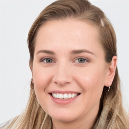 Joyful white young-adult female with long  brown hair and blue eyes