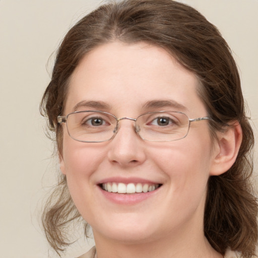 Joyful white young-adult female with medium  brown hair and blue eyes