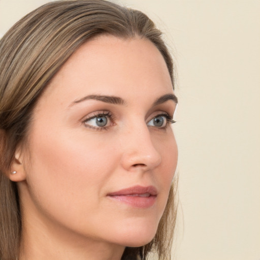 Joyful white young-adult female with long  brown hair and blue eyes