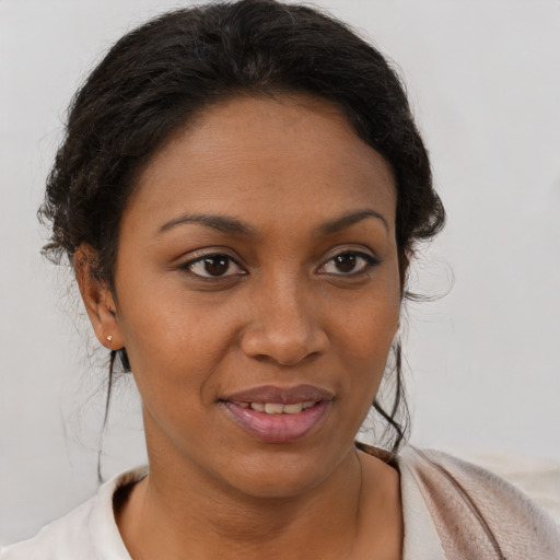 Joyful black young-adult female with short  brown hair and brown eyes