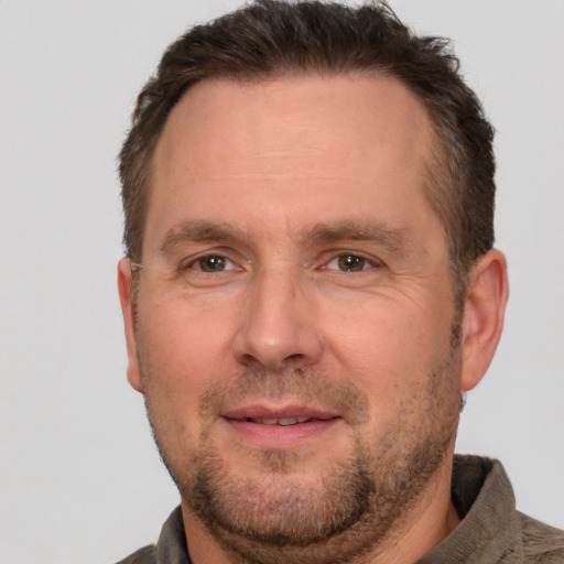 Joyful white adult male with short  brown hair and brown eyes