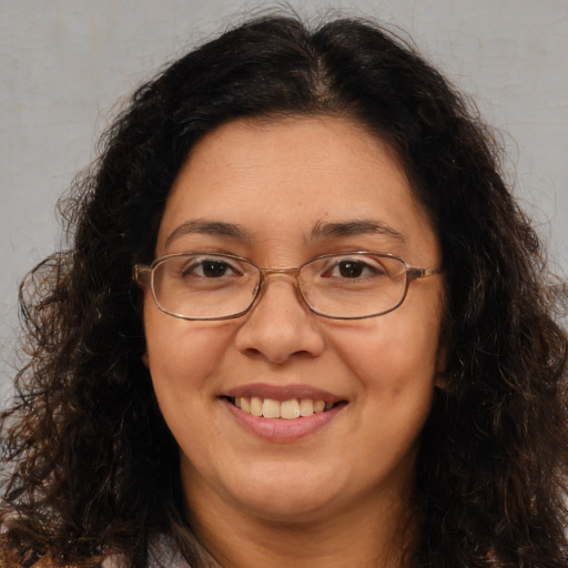 Joyful white adult female with long  brown hair and brown eyes