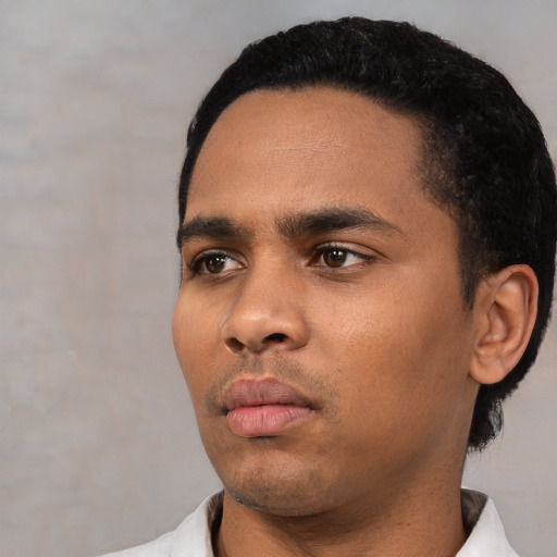 Neutral latino young-adult male with short  black hair and brown eyes