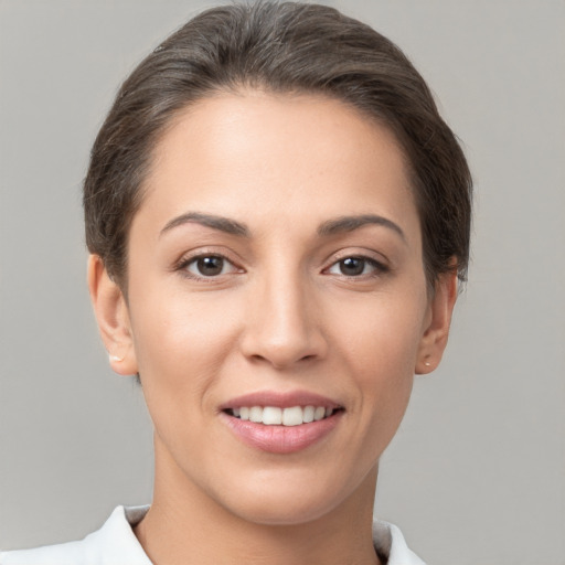 Joyful white young-adult female with short  brown hair and brown eyes