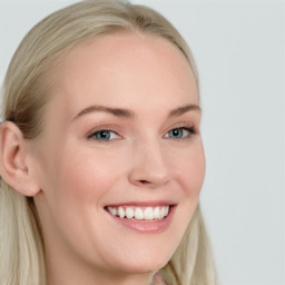 Joyful white young-adult female with long  brown hair and blue eyes