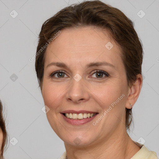 Joyful white adult female with medium  brown hair and brown eyes