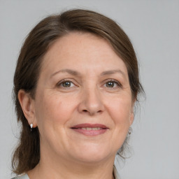 Joyful white adult female with medium  brown hair and grey eyes