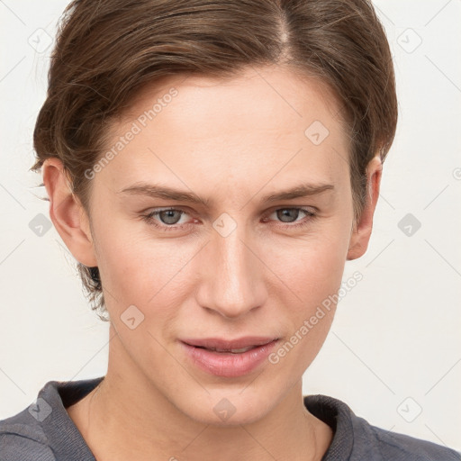 Joyful white young-adult female with short  brown hair and grey eyes