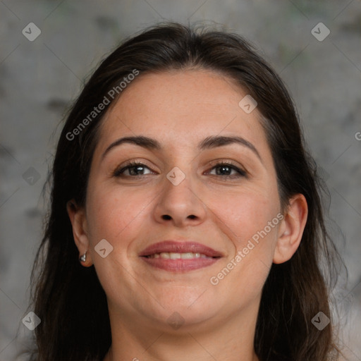 Joyful white adult female with long  brown hair and brown eyes