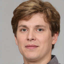 Joyful white adult male with short  brown hair and grey eyes