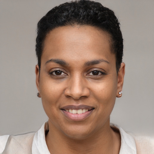 Joyful black young-adult female with short  black hair and brown eyes