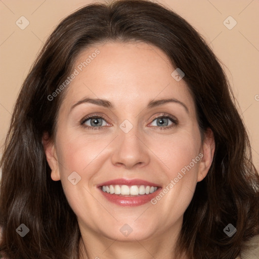 Joyful white adult female with long  brown hair and brown eyes