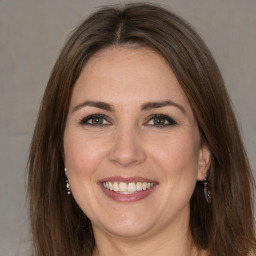 Joyful white adult female with medium  brown hair and brown eyes