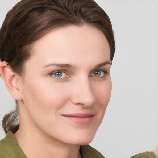 Joyful white young-adult female with short  brown hair and grey eyes