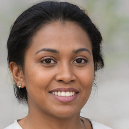 Joyful latino young-adult female with medium  brown hair and brown eyes