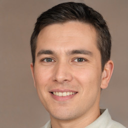 Joyful white young-adult male with short  brown hair and brown eyes