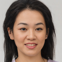 Joyful asian young-adult female with medium  brown hair and brown eyes