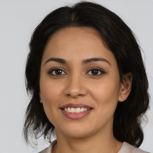 Joyful latino young-adult female with medium  brown hair and brown eyes