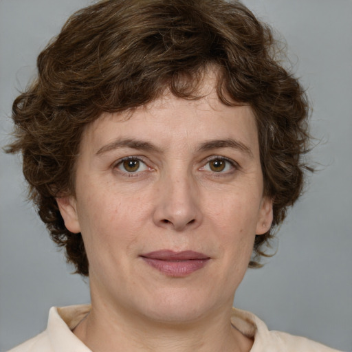 Joyful white adult female with medium  brown hair and green eyes