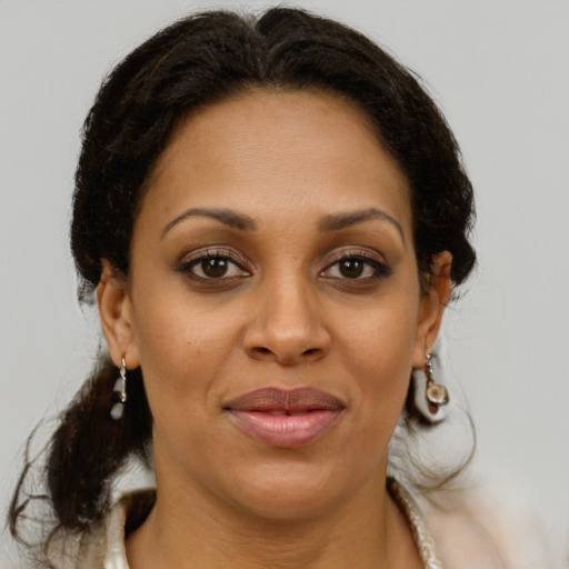 Joyful latino young-adult female with medium  brown hair and brown eyes