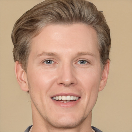 Joyful white adult male with short  brown hair and grey eyes