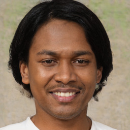 Joyful latino adult male with short  black hair and brown eyes