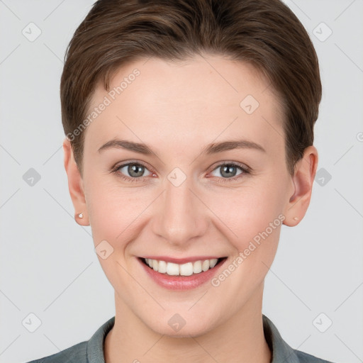 Joyful white young-adult female with short  brown hair and grey eyes