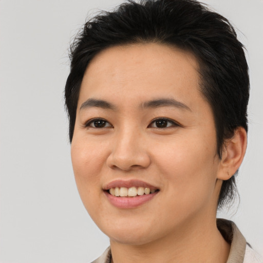 Joyful asian young-adult female with medium  black hair and brown eyes