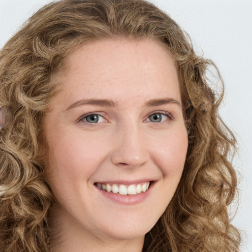 Joyful white young-adult female with long  brown hair and green eyes