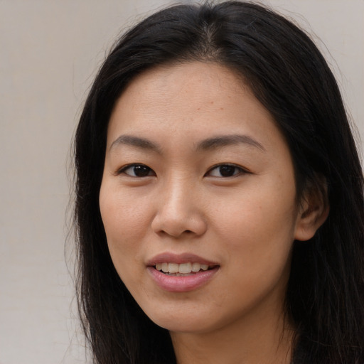 Joyful asian young-adult female with long  brown hair and brown eyes