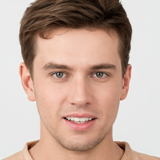 Joyful white young-adult male with short  brown hair and grey eyes