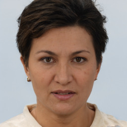 Joyful white adult female with short  brown hair and brown eyes