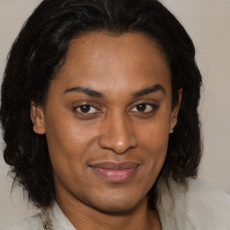 Joyful latino adult female with medium  brown hair and brown eyes