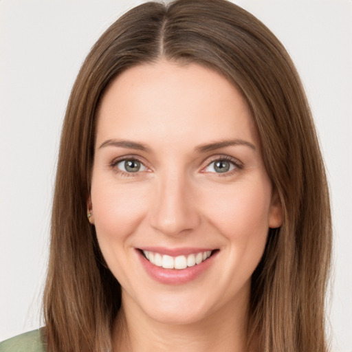 Joyful white young-adult female with long  brown hair and green eyes