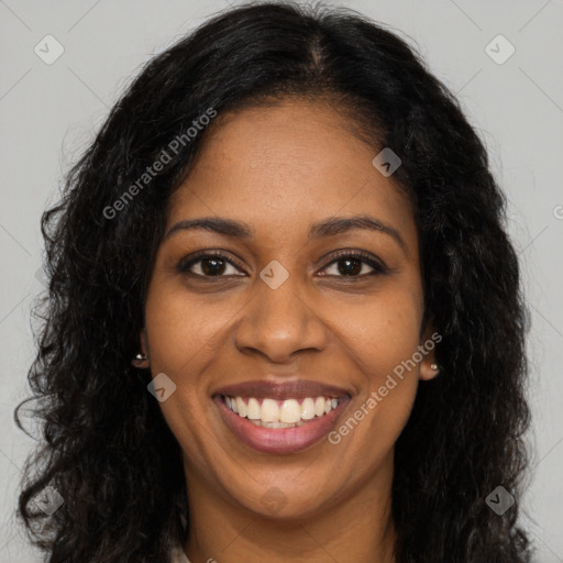 Joyful black young-adult female with long  brown hair and brown eyes