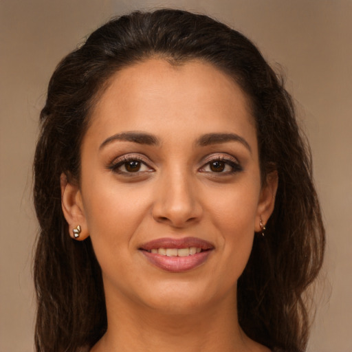 Joyful latino young-adult female with long  brown hair and brown eyes