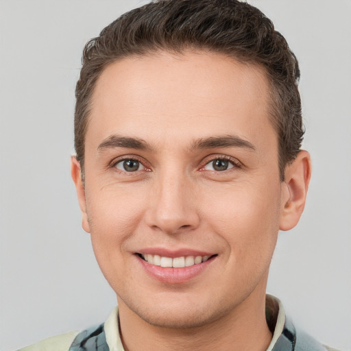 Joyful white young-adult male with short  brown hair and brown eyes