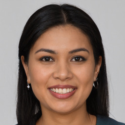 Joyful latino young-adult female with long  brown hair and brown eyes