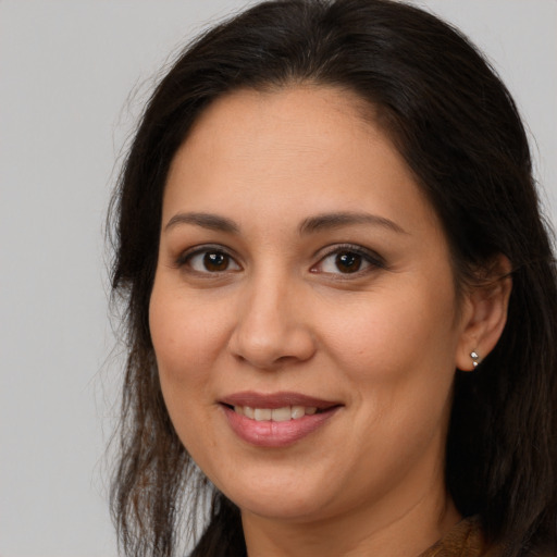Joyful white adult female with long  brown hair and brown eyes