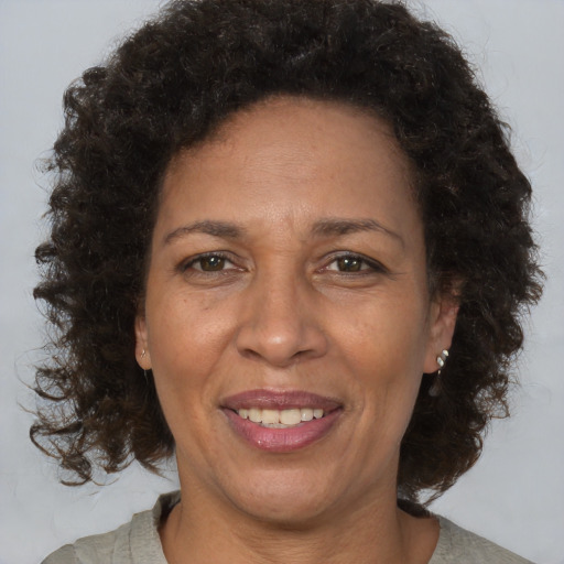 Joyful black adult female with medium  brown hair and brown eyes