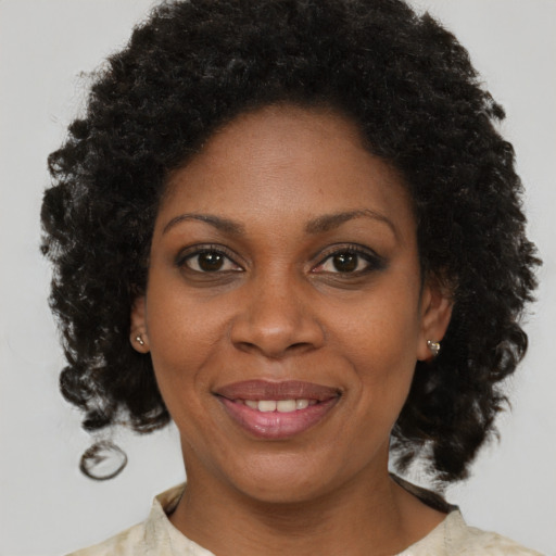Joyful black young-adult female with medium  brown hair and brown eyes