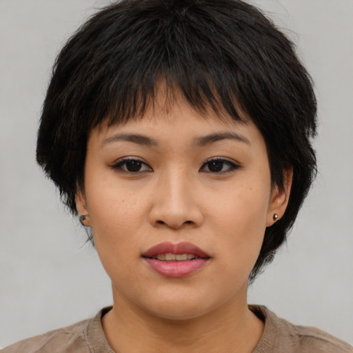 Joyful asian young-adult female with medium  brown hair and brown eyes