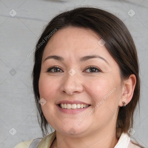 Joyful white adult female with medium  brown hair and brown eyes