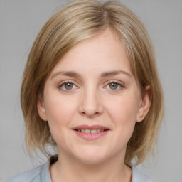 Joyful white young-adult female with medium  brown hair and blue eyes