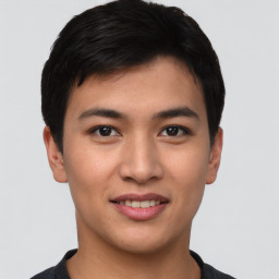 Joyful asian young-adult male with short  black hair and brown eyes