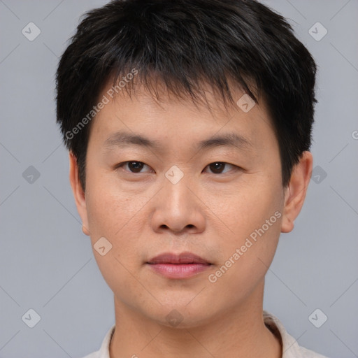 Joyful asian young-adult male with short  brown hair and brown eyes