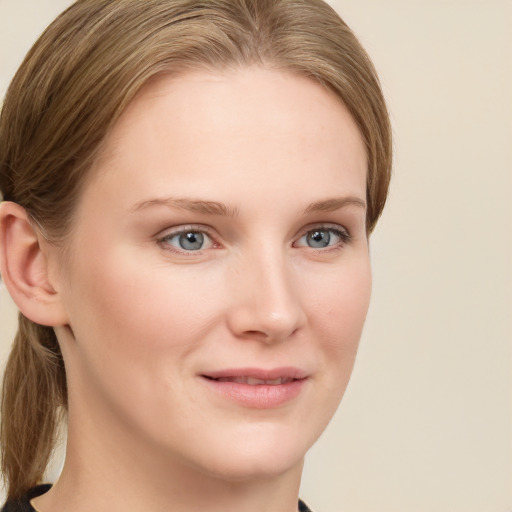 Joyful white young-adult female with long  brown hair and blue eyes