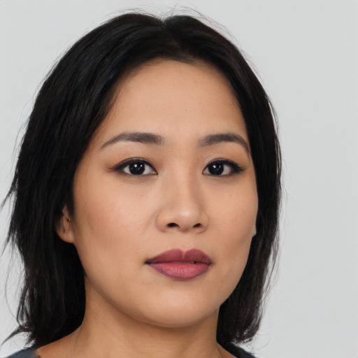 Joyful asian young-adult female with medium  black hair and brown eyes