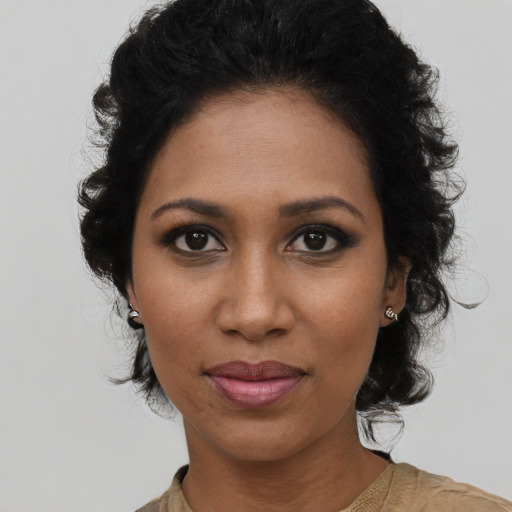 Joyful black young-adult female with medium  black hair and brown eyes