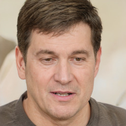 Joyful white adult male with short  brown hair and grey eyes